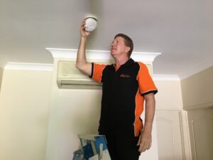 scott from glasshouse home safety smoke alarms inspecting a smoke alarm